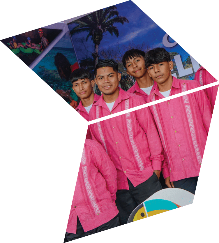 A group of young men wearing pink shirts and black pants. Description generated by AI