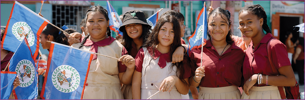 A group of girls holding flags and wearing uniforms. Description generated by AI